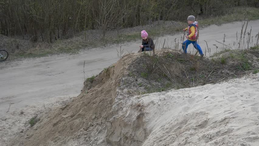 Children and teenagers have fun on the white sand. parkour