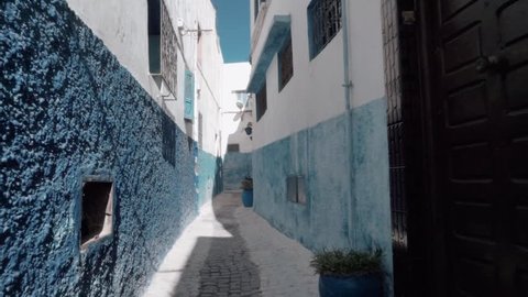 Steadicam shot of traditional old blue and withe street inside Medina of Chefchaouen city, Morocco
