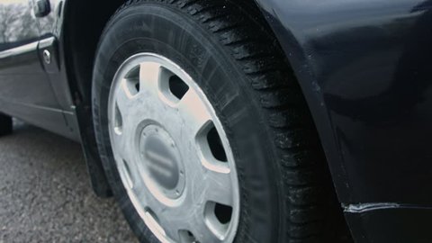 Closeup of a car wheel with a winter tyre