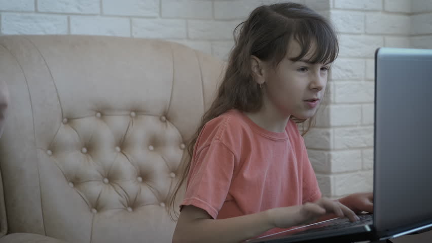 A child plays video games. Internet addiction. Parent pulls the child from the computer.