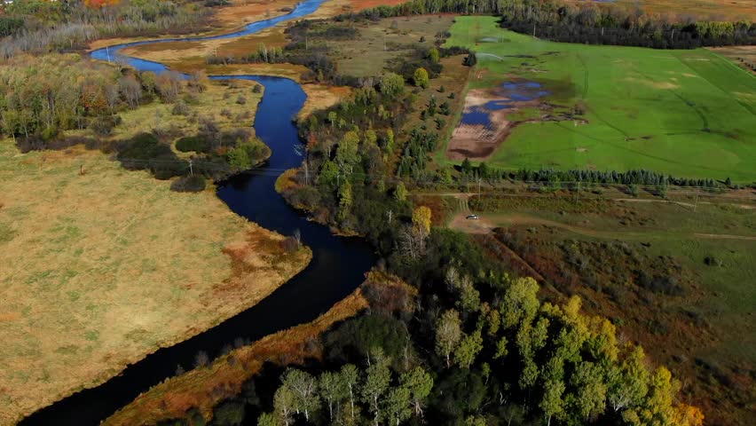 Warm Fall Colors in East Jordan River Northern Michigan Lake Charlevoix Blue Skys Blue Water Fresh Water.