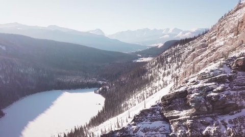 ARIEAL: 4K Drone shot of Lake and Canadian Rocky Mountains. Mountain Drone Ariel footage near Banff, Canmore, Jasper, Lake Louise, Canadian Rocky Mountains.