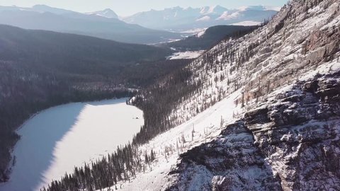 ARIEAL: 4K Drone shot of Lake and Canadian Rocky Mountains. Mountain Drone Ariel footage near Banff, Canmore, Jasper, Lake Louise, Canadian Rocky Mountains.