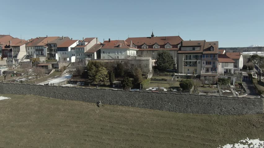 Wide fast low high drone shot of the old historical Swiss town Romont.