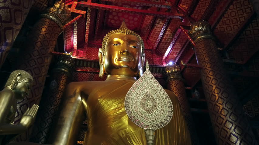 Revered golden Buddha statue at the ancient Wat Phanan Choeng temple in Ayutthaya, near Bangkok, Thailand. 