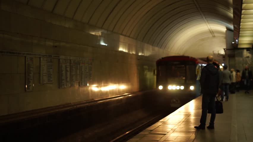 Moscow / Russia April 14 2019: Moscow subway metro. Train arriving at a subway station platform while commuters wait in line. people in Underground subway train station. | Shutterstock HD Video #1028220590