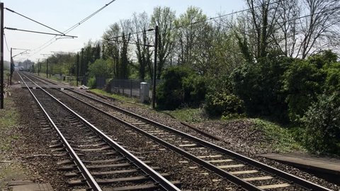 Welwyn, UK - April 22, 2019. British train from London to Cambridge passing at high speed near Digswell, Hertfordshire, England on a sunny afternoon.