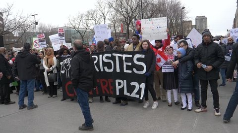 MONTREAL, CANADA - April 2019 : A huge multicultural crowd of people protesting against racism. Shot in Montreal, Quebec, Canada April 2019