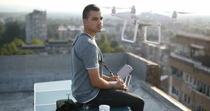 Young hipster man with flying drone. Aerial cityscape drone view