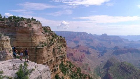 Hikers Looking Into the Grand Canyon by Aerial Drone