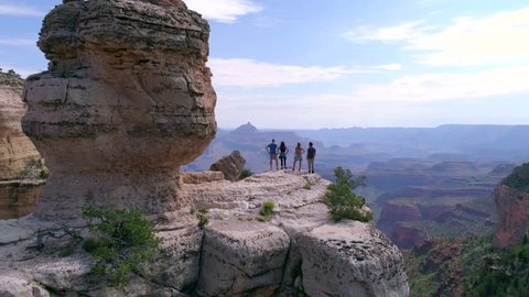 Hikers Looking Into the Grand Canyon by Aerial Drone