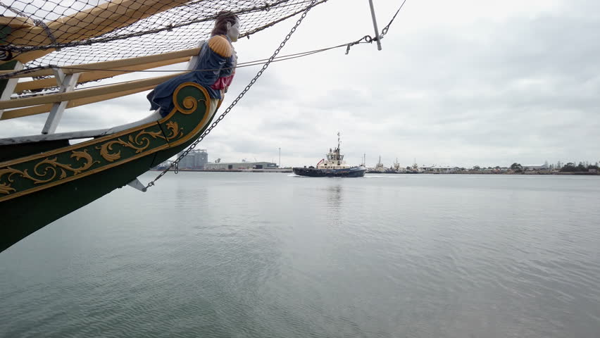 Tug boat cruising up the Hunter River in Newcastle alongside a pirate vessel