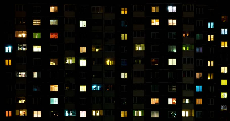 Night time lapse of Light in the windows of a multistory building. life in a big city. Serenade of light Royalty-Free Stock Footage #1028269853