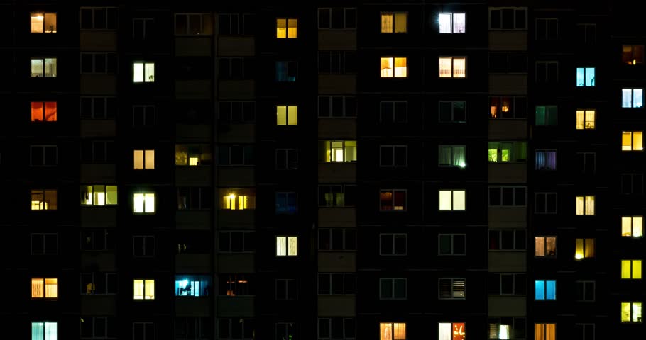 Night time lapse of Light in the windows of a multistory building. life in a big city. Serenade of light Royalty-Free Stock Footage #1028270057