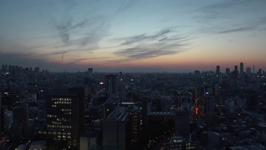 TOKYO,  JAPAN - CIRCA APRIL 2019 : Aerial sunrise view of CITYSCAPE of TOKYO around Shinjuku city and Ikebukuro city.  View from Bunkyo ward.  Time lapse shot.