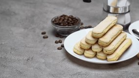Italian Savoiardi ladyfingers Biscuits and cup of coffee on concrete background