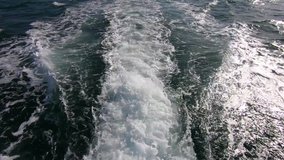 Cruise ship wake or trail on ocean surface. 