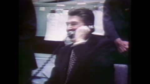 1980s: Mission control room. Ronald Reagan. Astronauts on ship. Door on space shuttle closes.