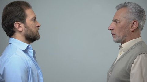 Senior and middle-aged men staring each other, male health, present and future