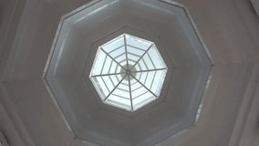Concrete octagonal roof with glass in the center. Hypnotic rotation. The view from the bottom up. White concrete. Several octagons and a window. Uniform location. Temple. Thailand. - Powered by Shutterstock - Get 15% off with code: PIKWIZARD15