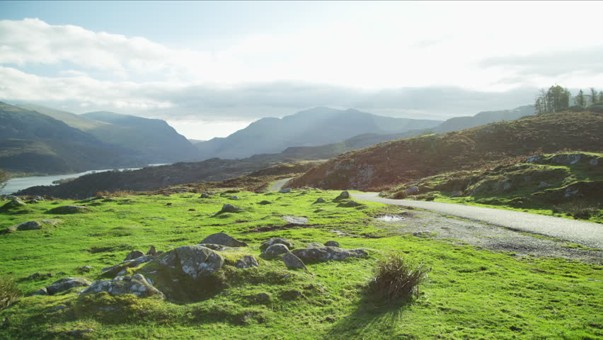 Young Caucasian European female hiker with rucksack Nordic walking to keep fit in mountains Snowdonia National Park Wales RED MONSTRO