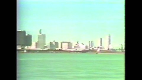CIRCA 1980s - 1982 DEA film in Japanese shows U.S. Customs agents patrolling Miami harbor looking for smugglers.