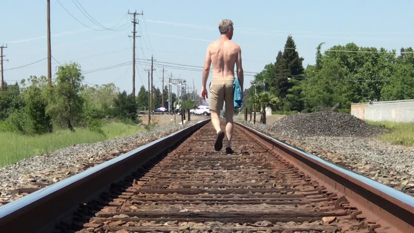 Guy Walking Down Train Tracks Stock Footage Video (100% Royalty-free)  1028336411 | Shutterstock