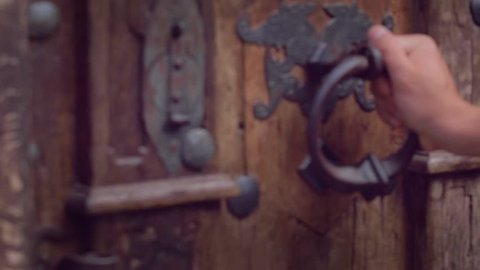 hand on an antique rusty old 
 door - opening