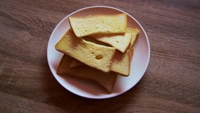 4K video of crispy butter toast on white plate, Thailand.