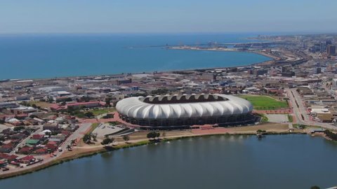 Port Elizabeth, South Africa - circa 2010s: Aerial view of Port Elizabeth city skyline, beautiful sunny summer day. Nelson Mandela Bay Stadium, North End Lake foreground, CBD and Harbour background