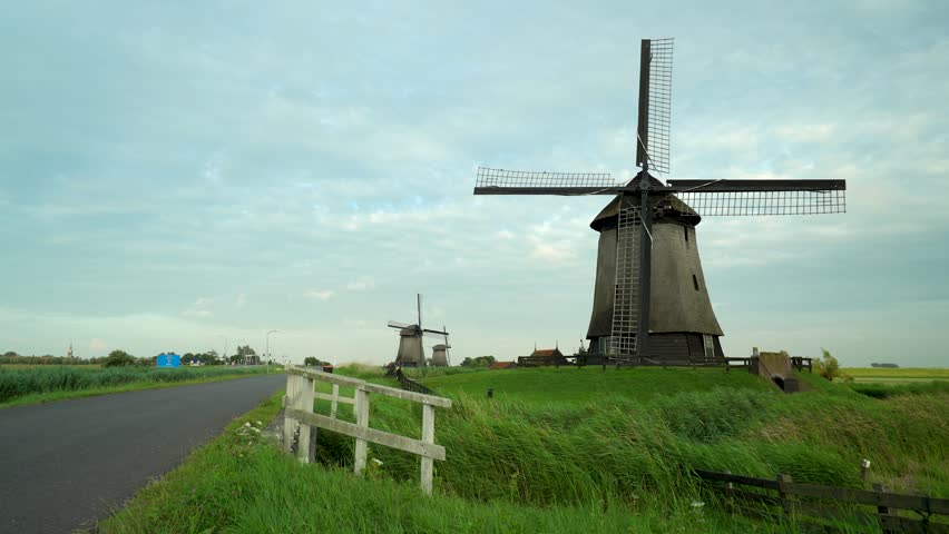 Static wide angle view of old traditional wind mills in the countryside near Amsterdam