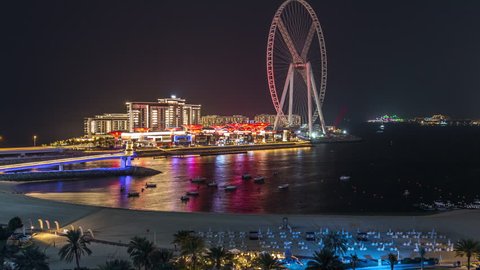 Bluewaters island and JBR aerial night timelapse with ferris wheel, new walking area with shopping mall and restaurants, newly opened leisure and travel spot in Dubai