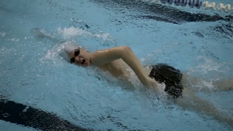Male swimmer doing freestyle in swimming pool, Slow motion, Full HD steadycam shot