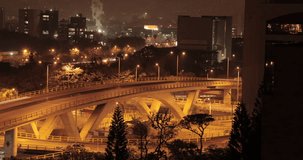 Night long exposure timelapse video to a bridge in the city, with traffic, buildings and factories. Medellin Colombia. 