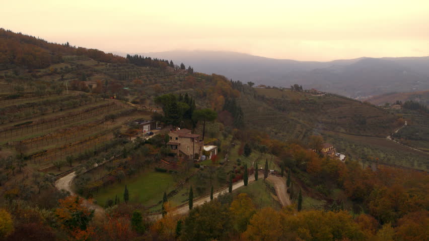 Aerial view of nature landscape beautiful hills forests fields and vineyards on an overcast day. Tuscany, Italy. 4k aerial