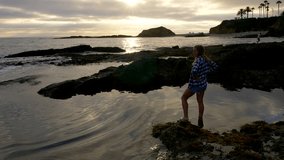 Woman Standing in the Tide Pools at Sunset - Powered by Shutterstock - Get 15% off with code: PIKWIZARD15