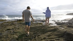Man and Woman on the Rocks at the Beach - Powered by Shutterstock - Get 15% off with code: PIKWIZARD15