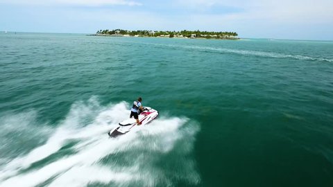 Key West, FL / USA - June 3, 2016: Waverunners Racing Through Tropical Islands, Jet Skis Along Key West Ocean Coast, Aerial Drone