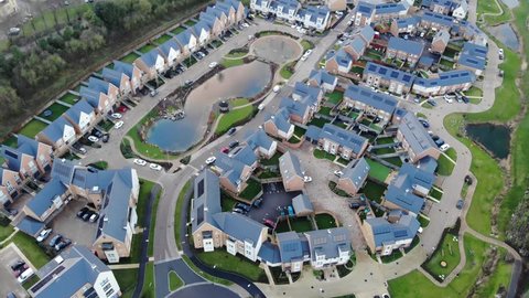 Aerial view of modern houses with an artificial pond in the middle in Greenhithe, Kent