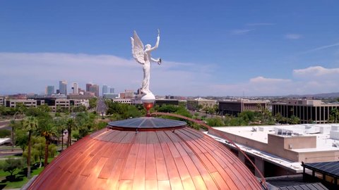 Phoenix, AZ / USA - June 5, 2016: Arizona Capitol Roof and Statue in Front of Phoenix Skyline, Aerial Drone
