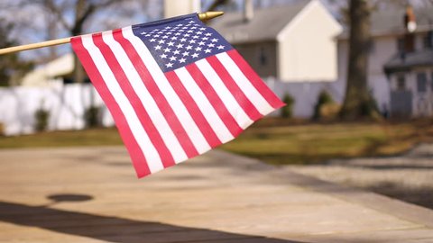American flag waving in the suburbs