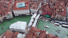Aerial drone video of iconic and unique Ponte Rialto or Rialto landmark bridge crossing Grand Canal, Venice, Italy