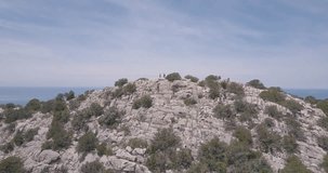 Hiking in Ibiza. Drone shot of people walking on cliff rocks in Ibiza. Ocean. Follow me around. Balearic Islands. Traveling Europe. Spain. Beautiful place. Travel video.