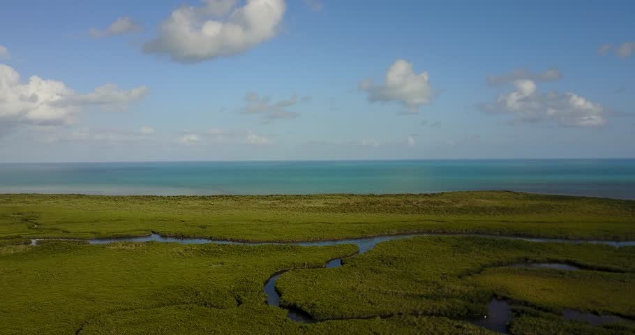 AERIAL: wide and straight push over the unique and abandoned looking terrain found in Key Largo, Florida.