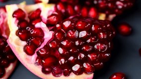 Close-up of rotating india pomegranate Seeds on black background in 4K resolution