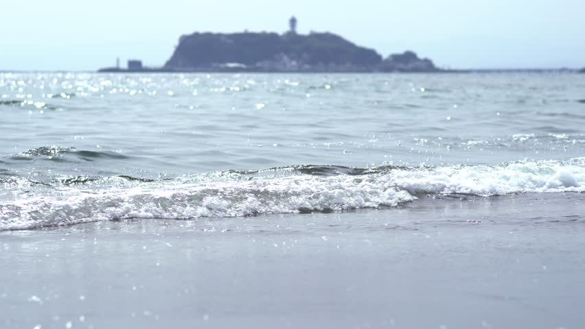 Landscape of the beach of "Shonan". The waves rush and pull. Kamakura, Kanagawa, Japan.