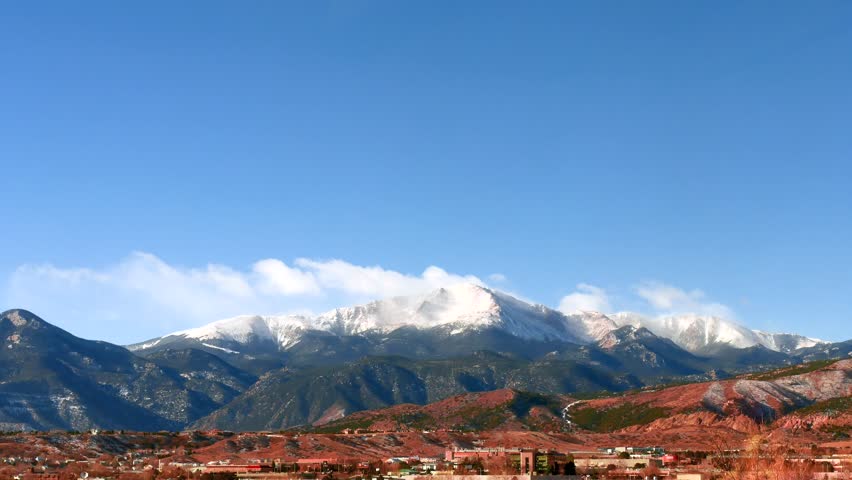 Timelapse of mountains and Pikes Peak on Sunny Day with fluffy clouds 4K