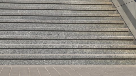 Granite steps in a city park on a sunny day. Staircase outside. Vision up the stairs. Close-up