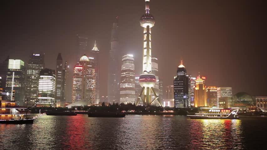 SHANGHAI - MARCH 19, 2018: View of Pudong embankment at night,Brightly illuminated tourist boat sail at Huangpu river,