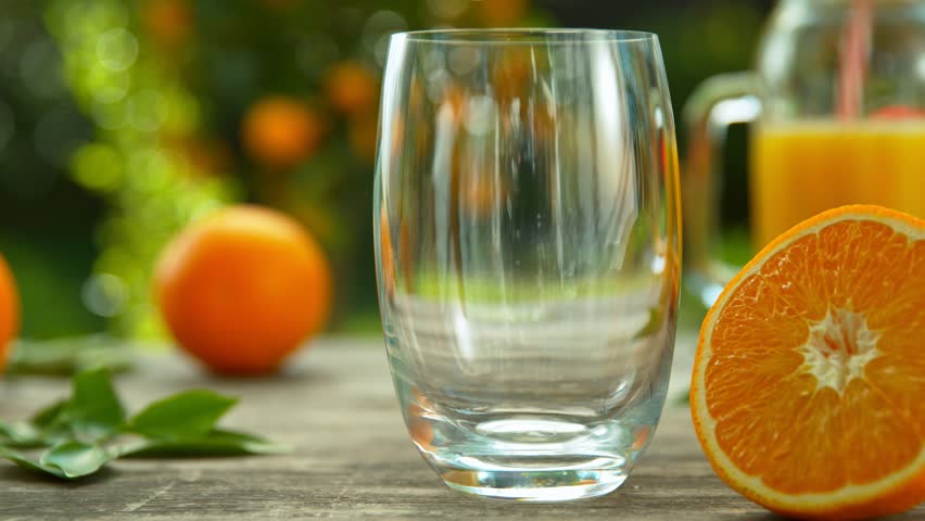 Super Slow Motion Shot of Fresh Orange Juice Being Poured in a Glass at 1000fps. Royalty-Free Stock Footage #1028430239